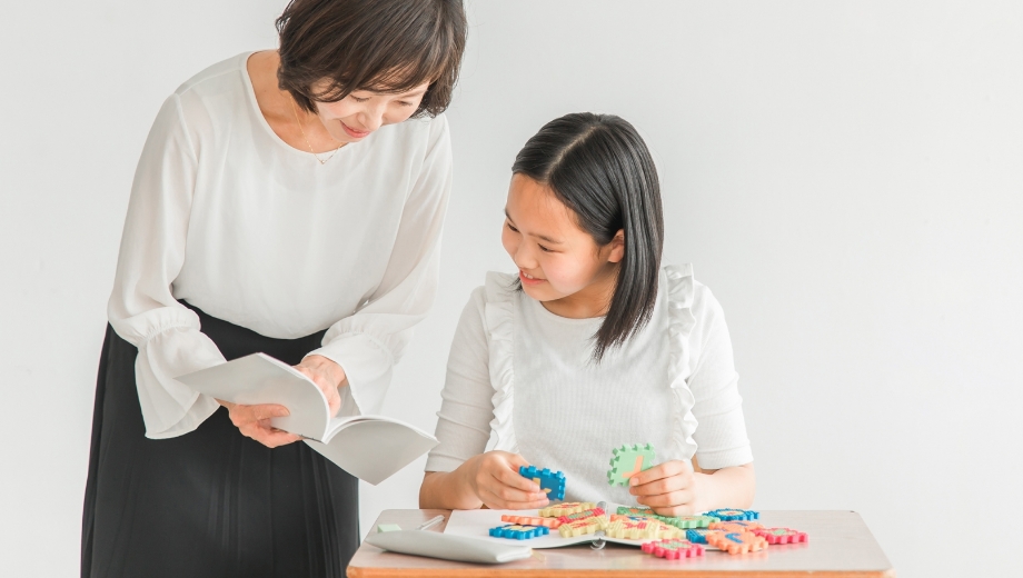 個別で勉強を教える先生と子ども